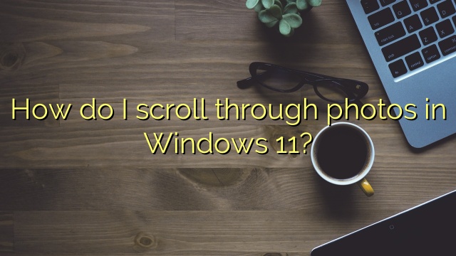 How do I scroll through photos in Windows 11?